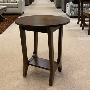 Round wooden side table in furniture showroom.