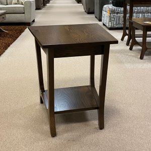 Wooden side table with shelf in furniture store.