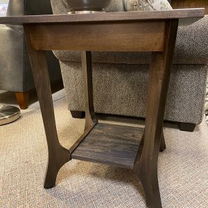 Wooden side table with vase on top.