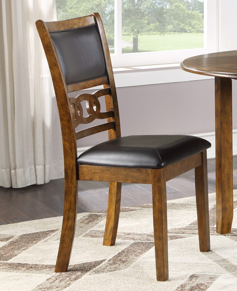 Wooden dining chair with black leather seat cushion.