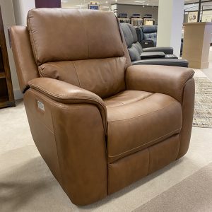 Brown leather recliner in furniture store showroom.