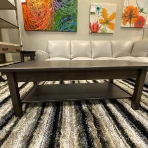 Modern living room with coffee table and paintings.