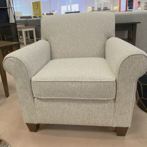 Gray upholstered armchair in furniture store.