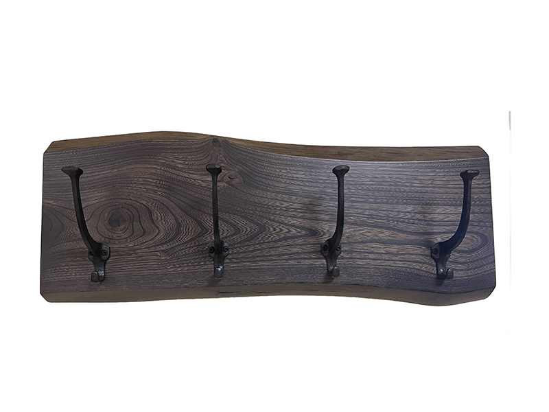 Wooden wall mount with four metal hooks.