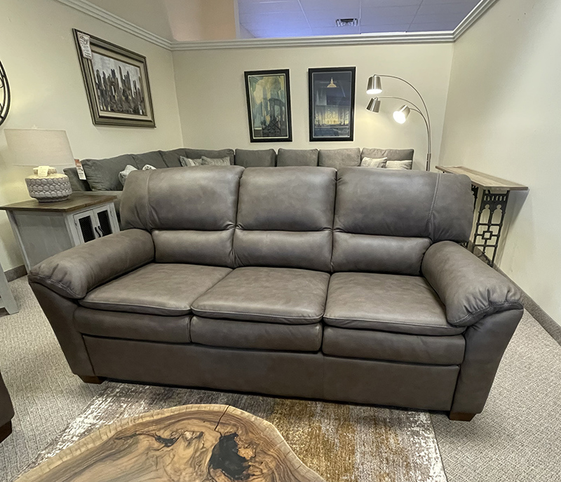 Gray leather sofa in a living room display.