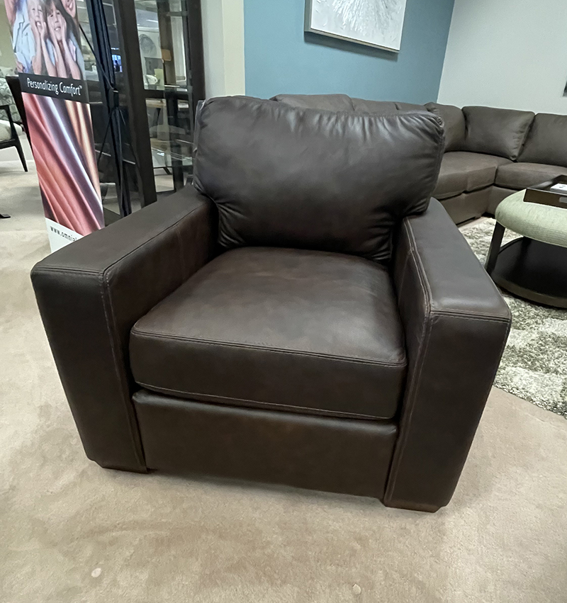 Brown leather armchair in living room setting.