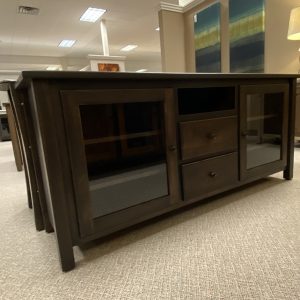 Wooden media console with drawers and glass doors.