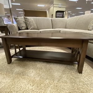 Wooden coffee table with beige sectional sofa