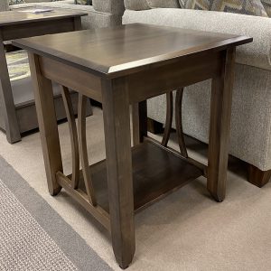 Wooden end table with lower shelf in living room.