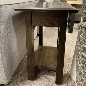 Dark wooden side table near a sofa