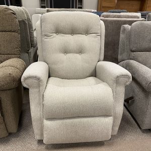 Comfortable gray armchair with button detailing.