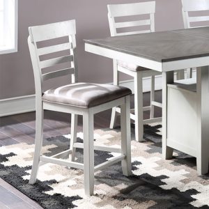 White wooden dining chairs and table setup.