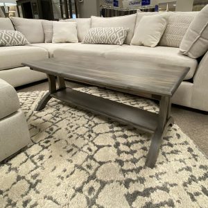 Gray coffee table with beige sectional sofa.