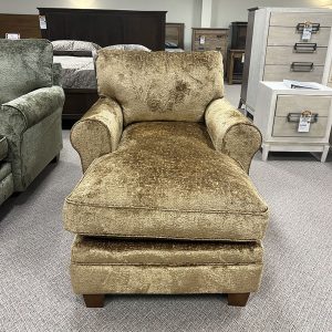Plush gold chaise lounge in furniture showroom.