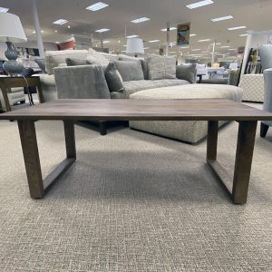 Modern wooden coffee table in furniture store.