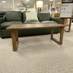 Wooden coffee table in furniture store display room.
