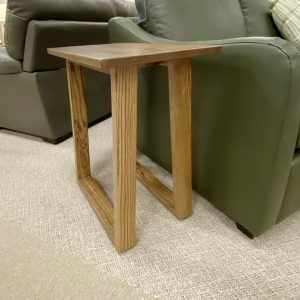 Wooden side table beside green sofa