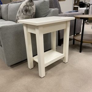 White side table near gray couch in living room.