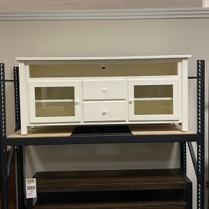 White wooden TV stand on display rack.
