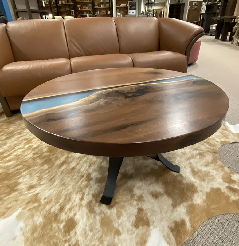Round wooden table, leather couch, cowhide rug