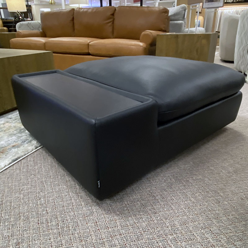 Black modern armchair in living room setting.