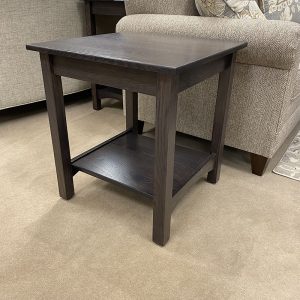 Dark wood side table beside sofa
