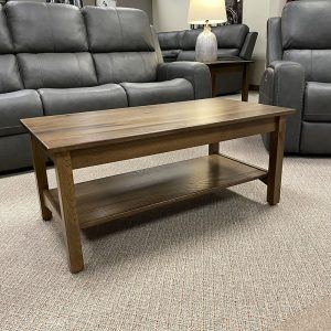 Wooden coffee table in living room with sofas.