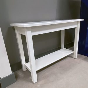 White wooden console table against gray wall