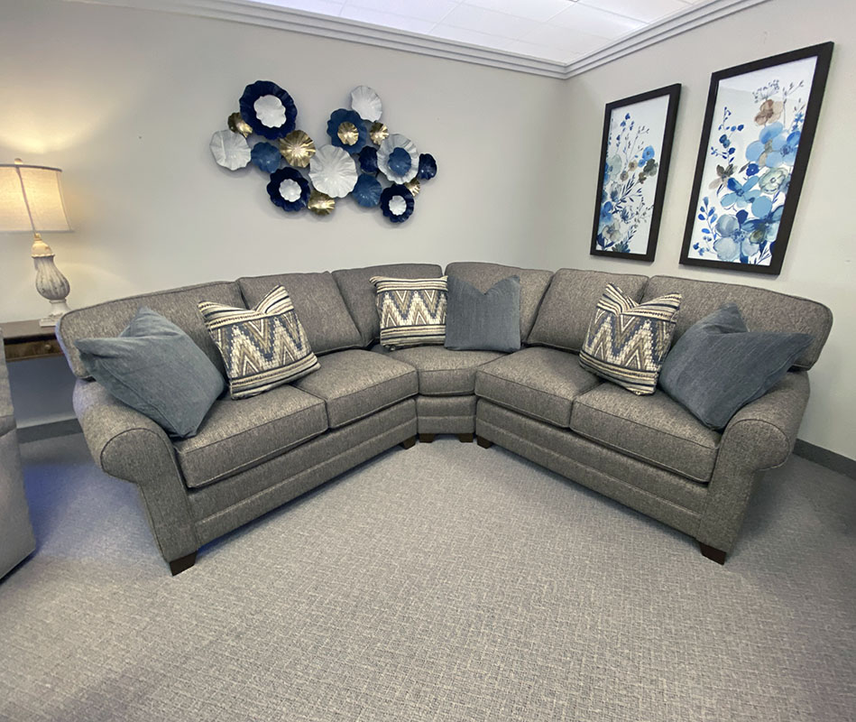 Gray L-shaped sofa in decorated living room.