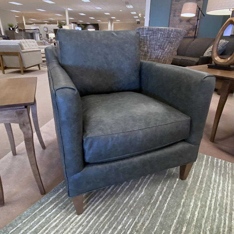 Gray armchair in a furniture store setting.