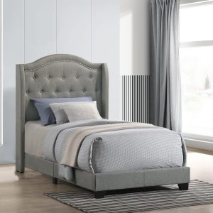 Elegant gray bed with tufted headboard in bedroom.