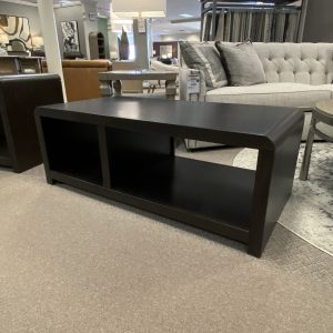 Modern dark wood coffee table in furniture showroom.