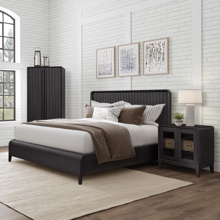 Modern bedroom with black bed and nightstand.