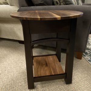 Round wooden side table in living room.