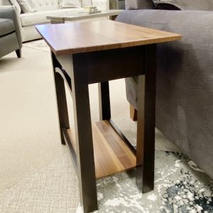 Wooden side table beside gray sofa in living room.