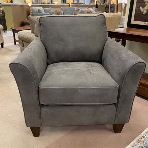 Gray upholstered armchair in furniture store
